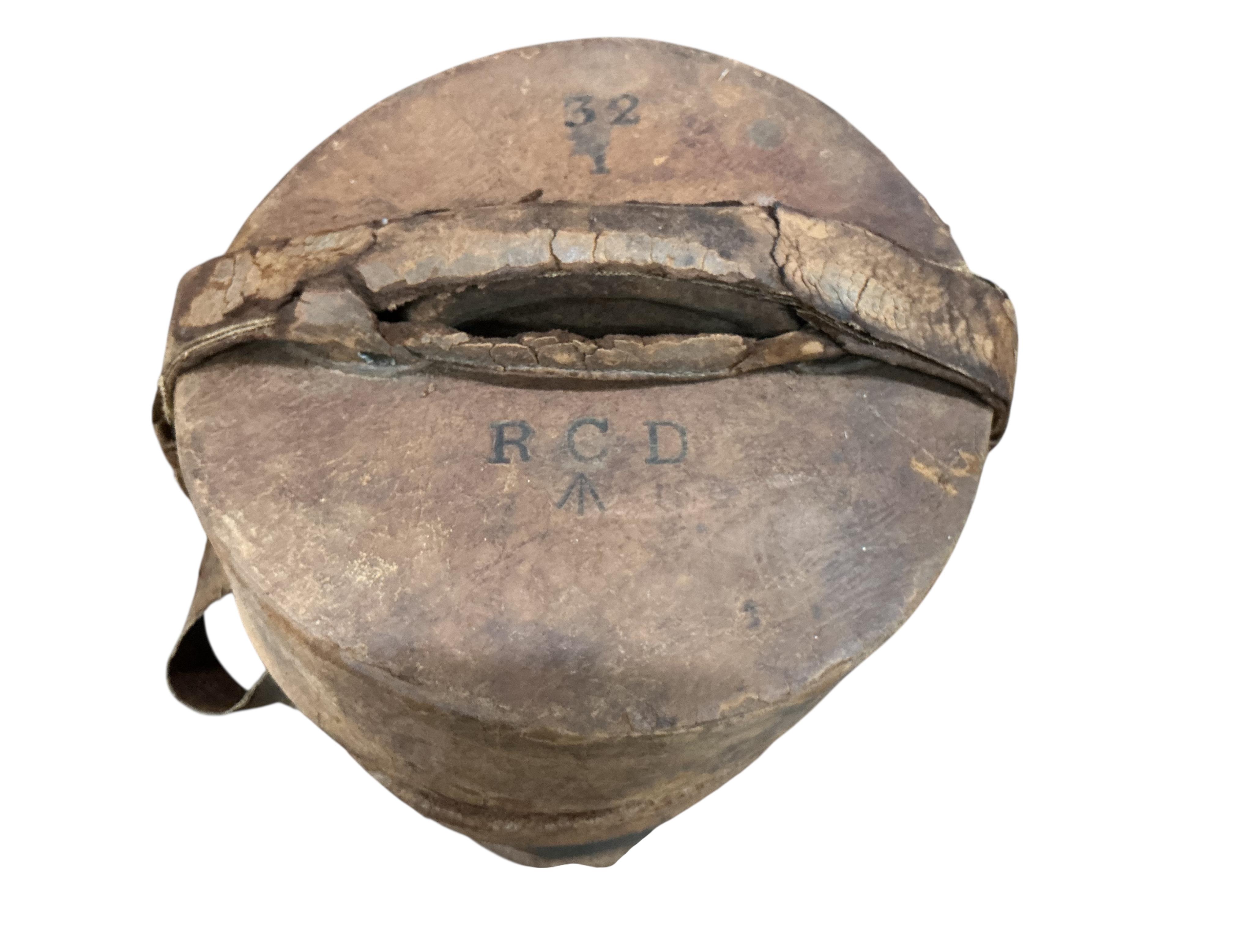 A WWI leather artillery shell case carrier, height 98cm, a wicker laundry hamper and a Revelation leather case